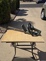 Full view of hedge trimmer on table showing body and blade