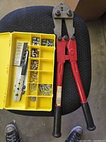 Bolt cutters alongside open organizer showing contents