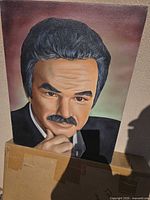 Front view of unframed canvas portrait painting showing Burt Reynolds