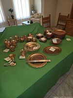 Full assortment of carnival glass dinnerware laid out on table