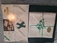 Both boxed napkin sets unopened