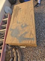 Top view of closed plywood box on gravel surface