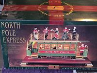 Retail box showing Maisto North Pole Express animated musical trolley and feature list