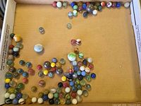 Overview of assorted marbles spread in box