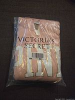 Folded light pink Victoria's Secret PINK sweatshirt sealed in plastic