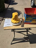 Polisher standing on table with manual and box visible