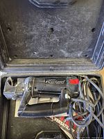 Spiral saw in opened hard case showing overall tool and cord