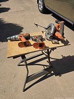 All three Ridgid cordless tools on small work table