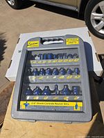 Full view of closed carry case showing 24 router bits and labeling