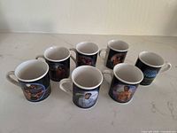 Seven mugs grouped on countertop