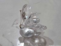Side view of Swarovski crystal butterfly figurine on frosted base