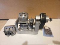 Overall view of engine on mount, muffler, and parts case