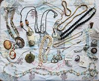 Overall view of entire jewelry lot spread on fabric