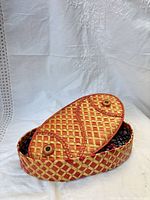 Box with lid resting ajar to show plaid weave and snaps