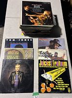 Stack of roughly 50 LP vinyl records with several covers displayed including Tom Jones, Fiddler on the Roof, Juiciest Fruitgum, Marvelous Moods and others