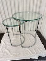 front view of both round glass nesting tables showing size difference