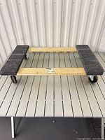Top view of wood furniture dolly on slat table