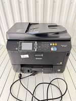 Front view of Epson WF-4630 printer with power cable