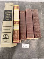 Five books standing upright showing spines and titles
