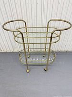 Full frontal view of brass and glass bar cart