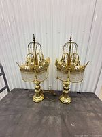 Full view of both brass lamps on table