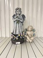 Front view of both statues on shelf