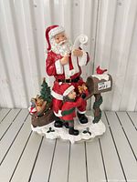 Front view of resin Santa figurine with child and mailbox