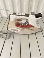 Side view of Rowenta steam iron showing body, water tank, controls and cord