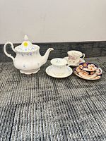 Full set showing teapot, three cups and three saucers