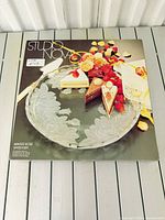 Front of retail box showing Studio Nova Winter Rose platter