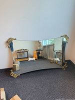 Full view of rectangular mirror with gilded corner ornaments