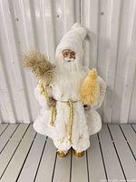 Full view of white Santa figurine standing on floor