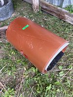 Full roll of brown trim coil lying on ground