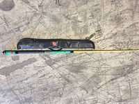 Pool cue assembled beside soft case