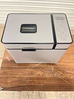 Top view of Cuisinart bread maker showing viewing window and silver/black exterior