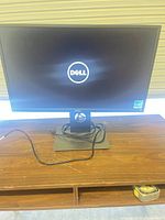 Front view of Dell monitor on stand with cables