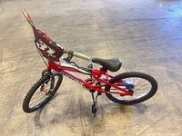 Full side view of red and black Dynacraft Wipe Out kids bicycle