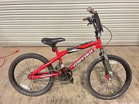 Side view showing full bicycle, frame graphics, seat, wheels and drivetrain