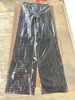 Full view of pants front showing wide-leg cut and croc pattern