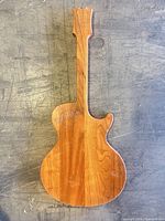 Full view front of guitar-shaped wood board