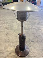 Full view of patio heater showing reflector, emitter, support pole and base
