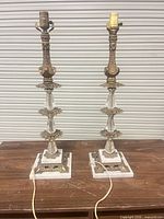 Front view of both matching brass, crystal and marble table lamps