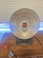 Front view of Presto HeatDish Plus Tilt heater showing reflector and branding