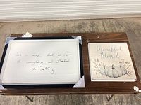 Both wall art pieces on table showing designs