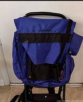 Full view of blue Camp Trails external frame backpack showing front pockets and frame