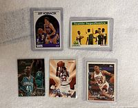 Five sleeved basketball cards including Jeff Hornacek, Seattle SuperSonics team, Glen Rice, Patrick Ewing, Scottie Pippen