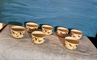 seven small bowls arranged in two rows