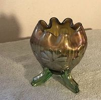 Front view of iridescent carnival glass bowl showing scalloped rim and floral pattern