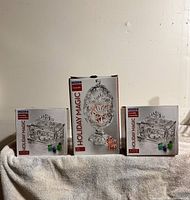 Front view of three boxed Luminarc Holiday Magic crystal candy dishes