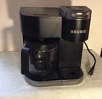 Front view of Keurig coffee maker with carafe in place